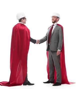 Architect and developer in capes super heroes shaking hands Foto stock