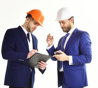 Architect and engineer discuss project. Business partners look at building plan. Fotos de archivo