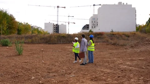 Architect and engineer discussing future project with investor on construction Stock Footage 334553777