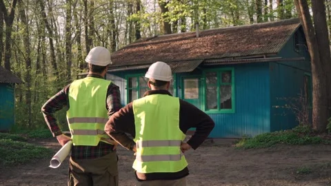 Architect and engineer discussing a plan to build a country house. Stock Footage 241177797