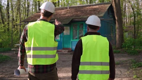 Architect and engineer discussing a plan to build a country house Stock Footage 241178132