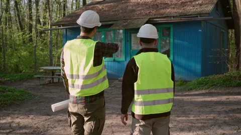 Architect and engineer discussing a plan to build a country house. Stock Footage 241404882