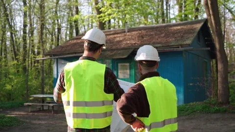 Architect and engineer discussing a plan to build a country house Stock Footage 241405019
