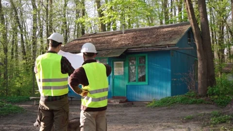 Architect and engineer discussing a plan to build a country house Stock Footage 241405093