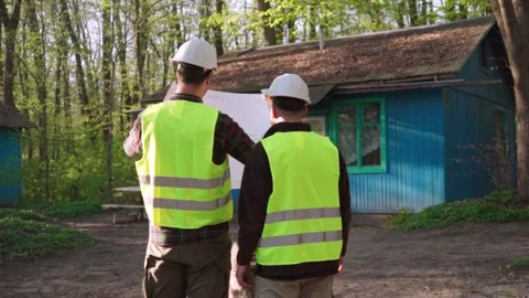 Architect and engineer discussing a plan to build a country house Stock Footage 241405130