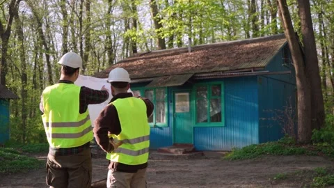 Architect and engineer discussing a plan to build a country house. Stock Footage 241493169