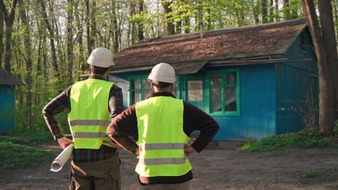 Architect and engineer discussing a plan to build a country house. Stock Footage 242166464