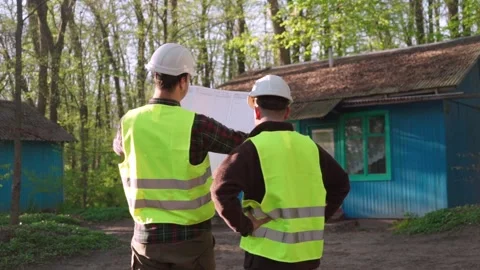 Architect and engineer discussing a plan to build a country house Stock Footage 242596661