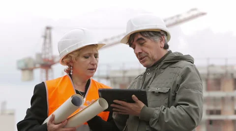 Architect and engineer looking at plan on construction site Stock Footage 35154627