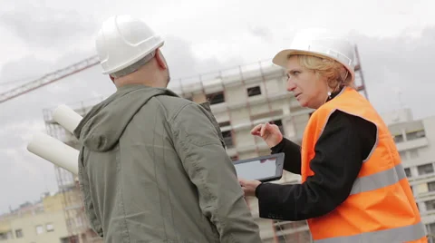 Architect and engineer looking at plan on construction site Stock Footage 35154803