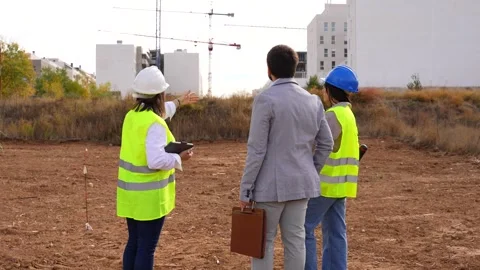 Architect and engineer presenting building project to an investor on site Stock Footage 334555218