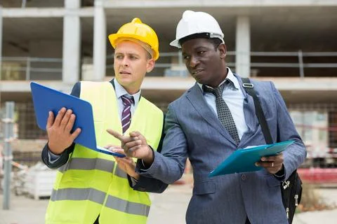 Architect and engineer talking about project of new building Stock Photos