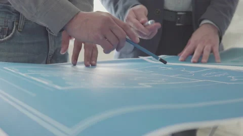 Architect and Engineer in a team discussing house blueprints Video stock 133054575