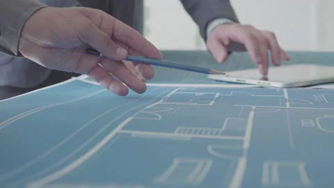 Architect and Engineer in a team discussing house blueprints 動画素材 133054667