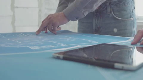 Architect and Engineer in a team discussing house blueprints Video stock 133054847
