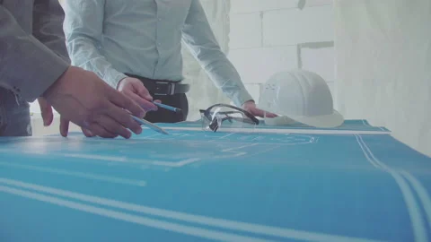 Architect and Engineer in a team discussing house blueprints Video stock 133055778