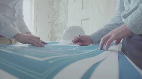 Architect and Engineer in a team discussing house blueprints Video stock 133056198
