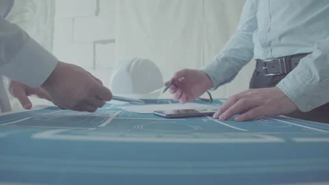 Architect and Engineer in a team discussing house blueprints Video stock 133056261