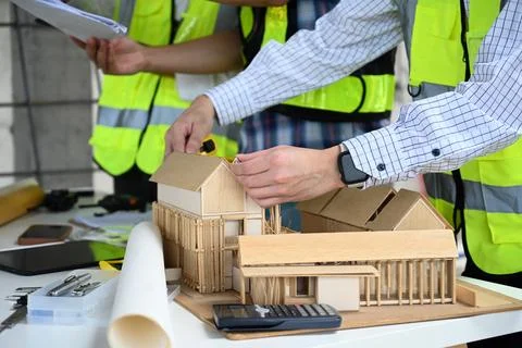 Architect and engineer team discussing about about design building at Stock Photos