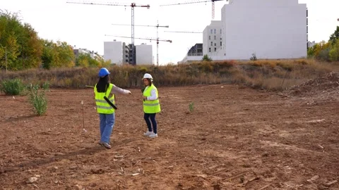 Architect and engineer walking on a construction site Stock Footage 334554771