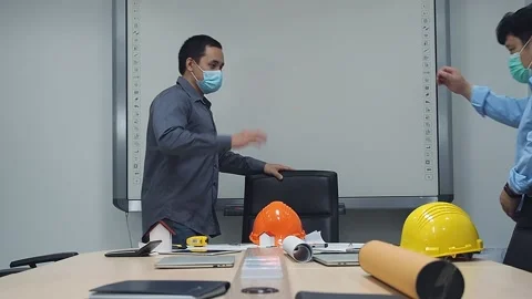 Architect and engineer wear protective face mask new greeting with elbow bump. Stock Footage 141860247