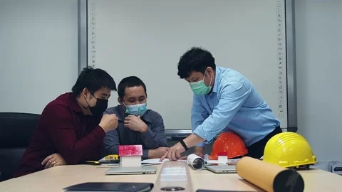Architect and engineer wearing protective masks working together in a office. Stock Footage 142345203