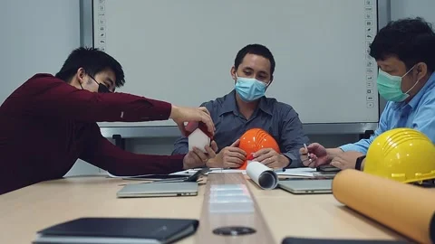 Architect and engineer wearing protective masks working together in a office. Stock Footage 148454943