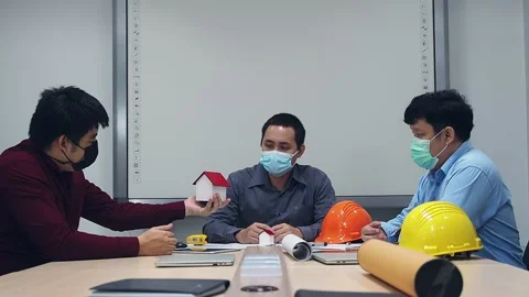 Architect and engineer wearing protective masks discussing in meeting room. Stock Footage 149474099