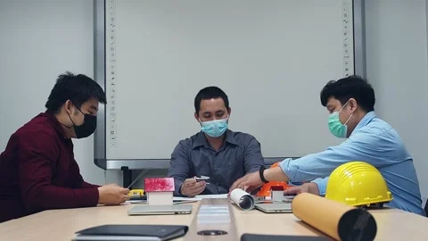 Architect and engineer wearing protective masks working in a meeting room. Stock Footage 151887105