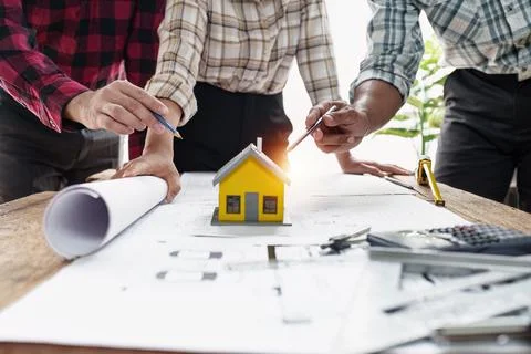 Architect and Engineer working with blueprints for architectural plan, engineer Stock Photos