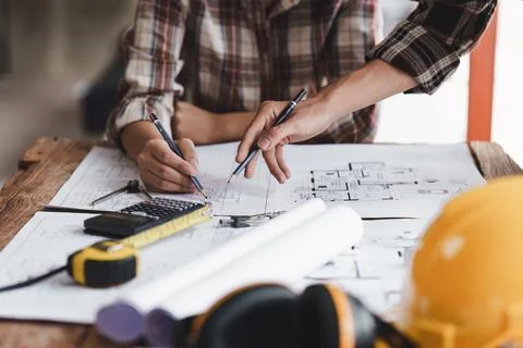 Architect and Engineer working with blueprints for architectural plan, engineer Foto stock