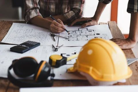 Architect and Engineer working with blueprints for architectural plan, engineer Foto stock
