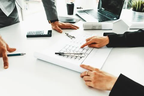 Architect and engineer working with drawing. uds Fotos de archivo