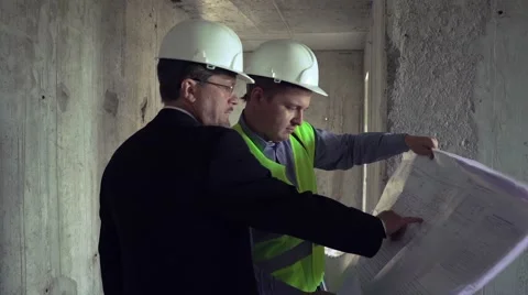 Architect and foreman discussing construction plan Stock Footage 65160217