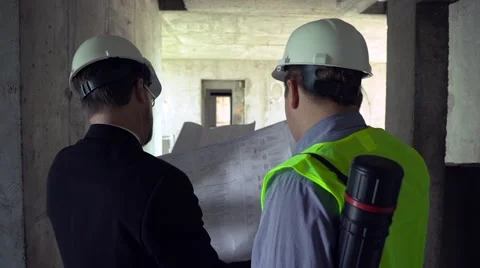 Architect and foreman looking at development plan Stock Footage 65159742