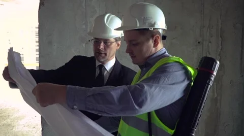 Architect and foreman looking at development plan Stock Footage 65159933