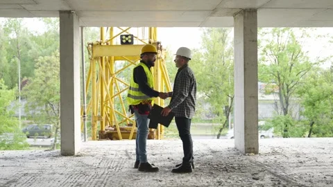 Architect and foreman shaking hands at construction site Stock Footage 343450516