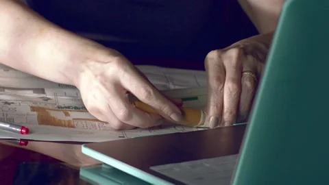 Architect and interior designer using a highlighter and ruler to mark up Stock Footage 227274299