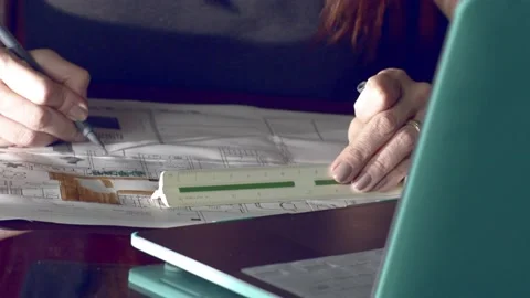 Architect and interior designer working on project plan blueprints in her Stock Footage 227276044