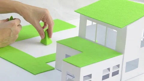 Architect and a model of green house Stock Footage 70169826