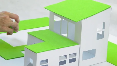Architect and a model of green house Stock Footage 70169900