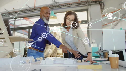 Architect and project manager examining architecture model in office, showing Stock Footage 308655853