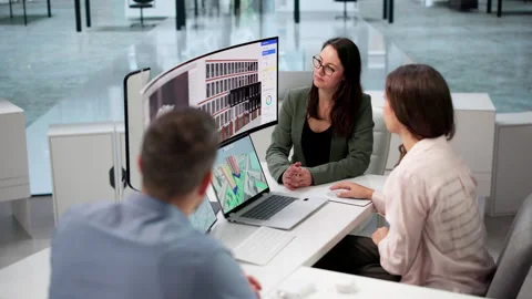 Architect And Team Discuss 3D BIM Modeling Using Laptop Stock Footage 347906144