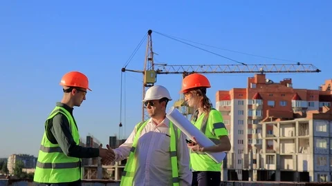 The architect and two young engineers guy and girl show thumb up. show the OK Stock-Footage 105697111