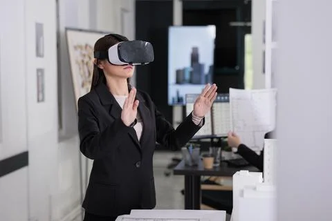 Architect in ar helmet touching virtual building project Fotos de archivo