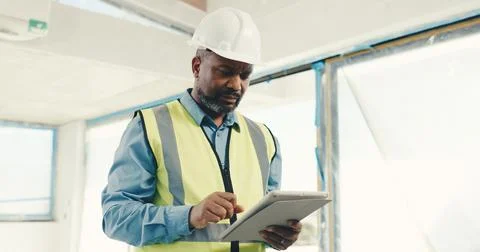 Architect, black man and tablet on construction site for inspection, safety Foto stock