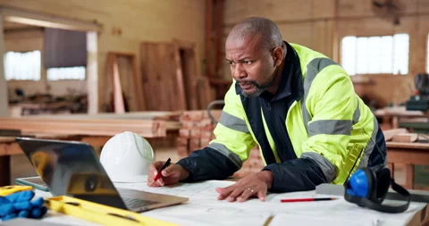 Architect, blueprint and black man with laptop for construction development or Stock Footage 337985789