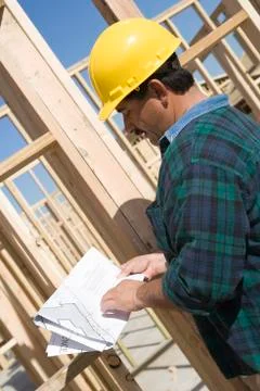 Architect With Blueprint At Construction Site Stock Photos