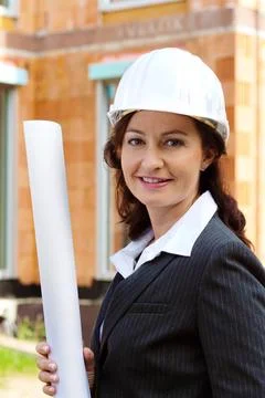  Architect with blueprint on construction site before shell Architektin mi... Stock Photos