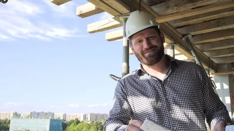 Architect browsing building project, smiles to camera. 库存影片 70804289
